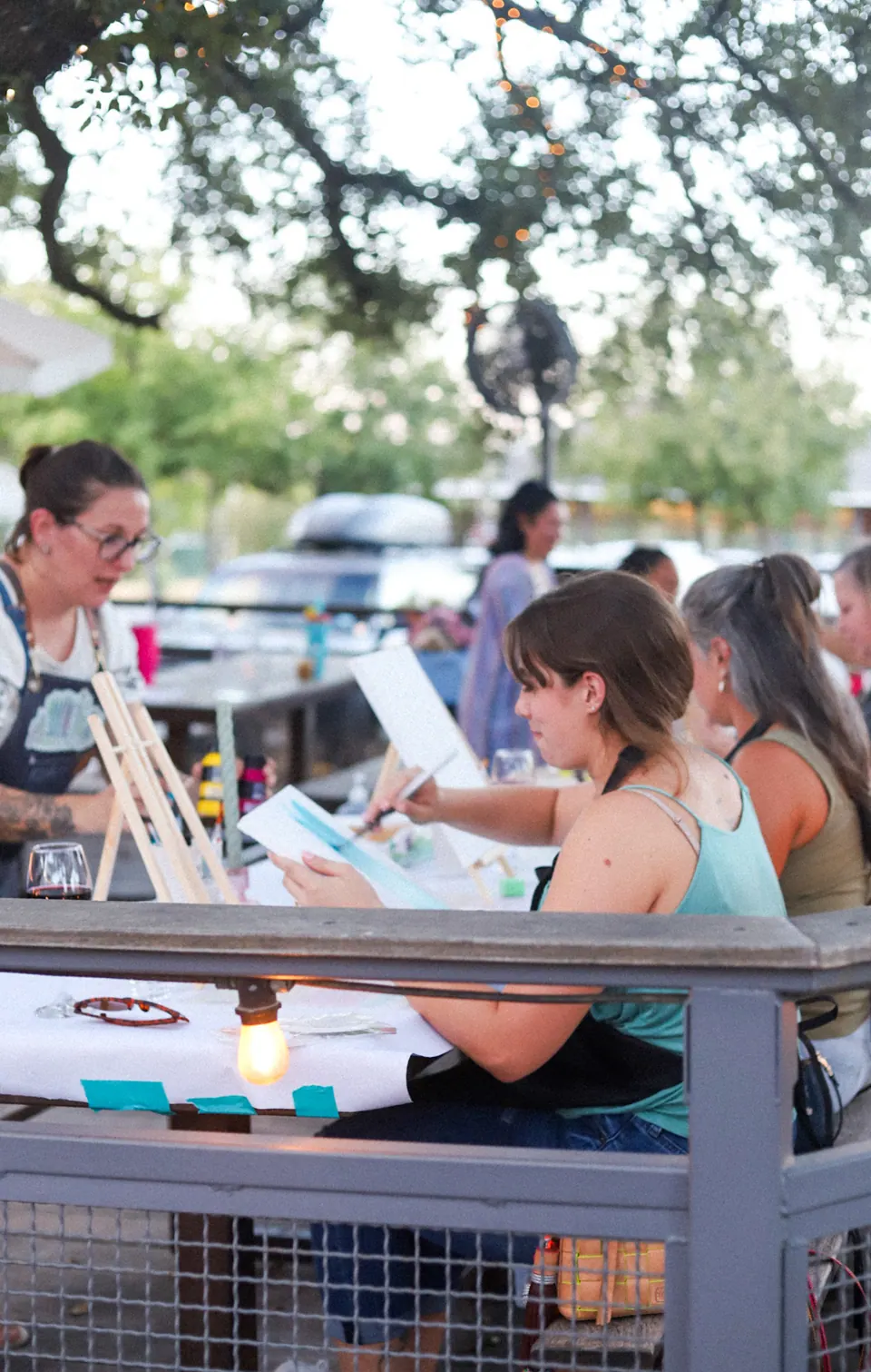 Guests enjoying a painting session around a shared table