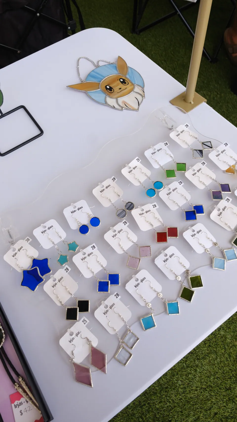Colourful handmade glass earrings on a market display