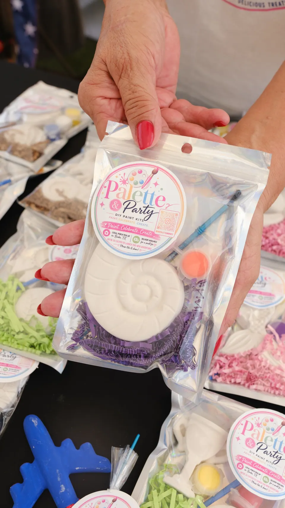 A vendor showing a Palette and Party take-home painting kit