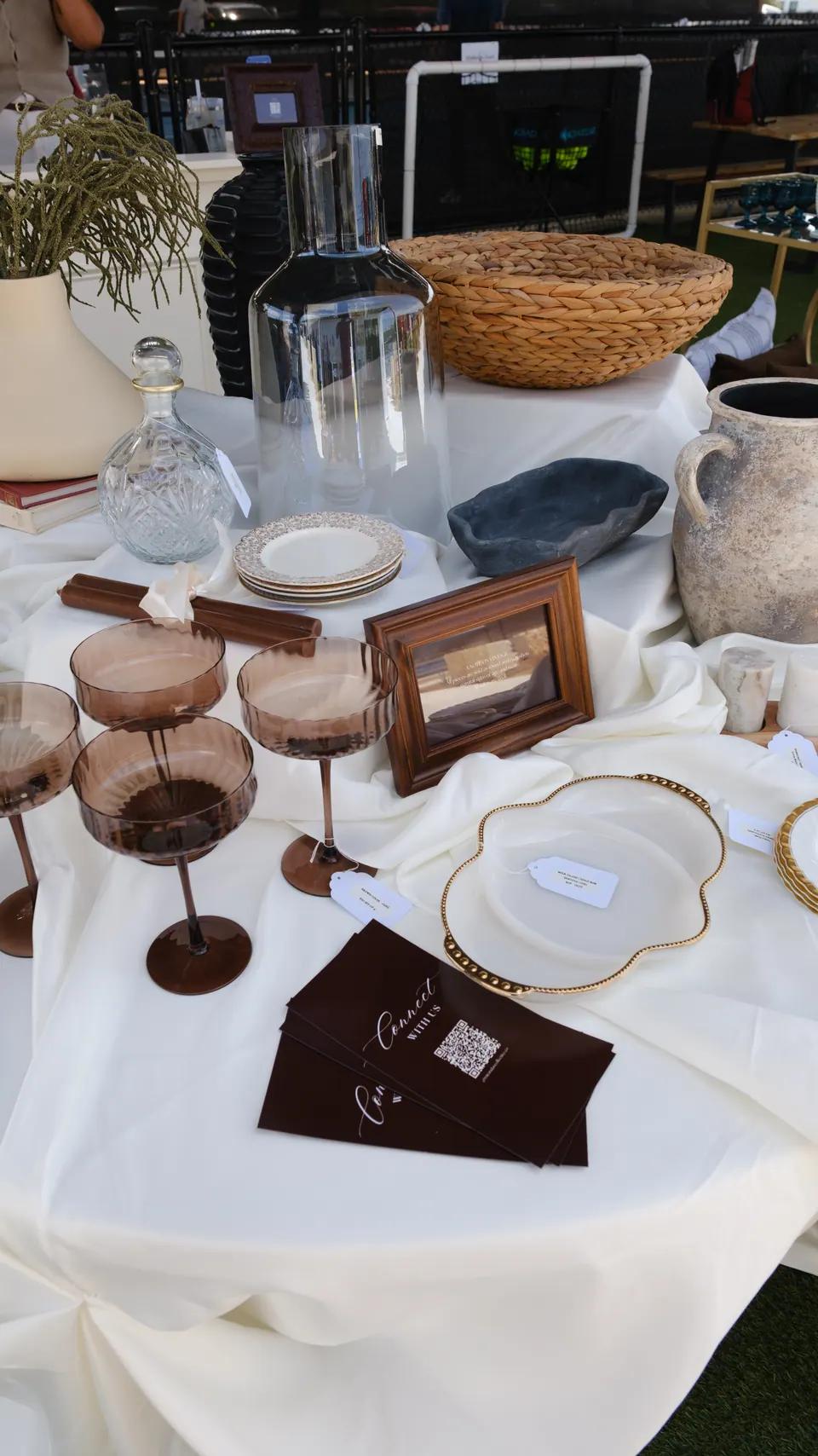 Vintage glassware, ceramics and woven homewares at a market stall